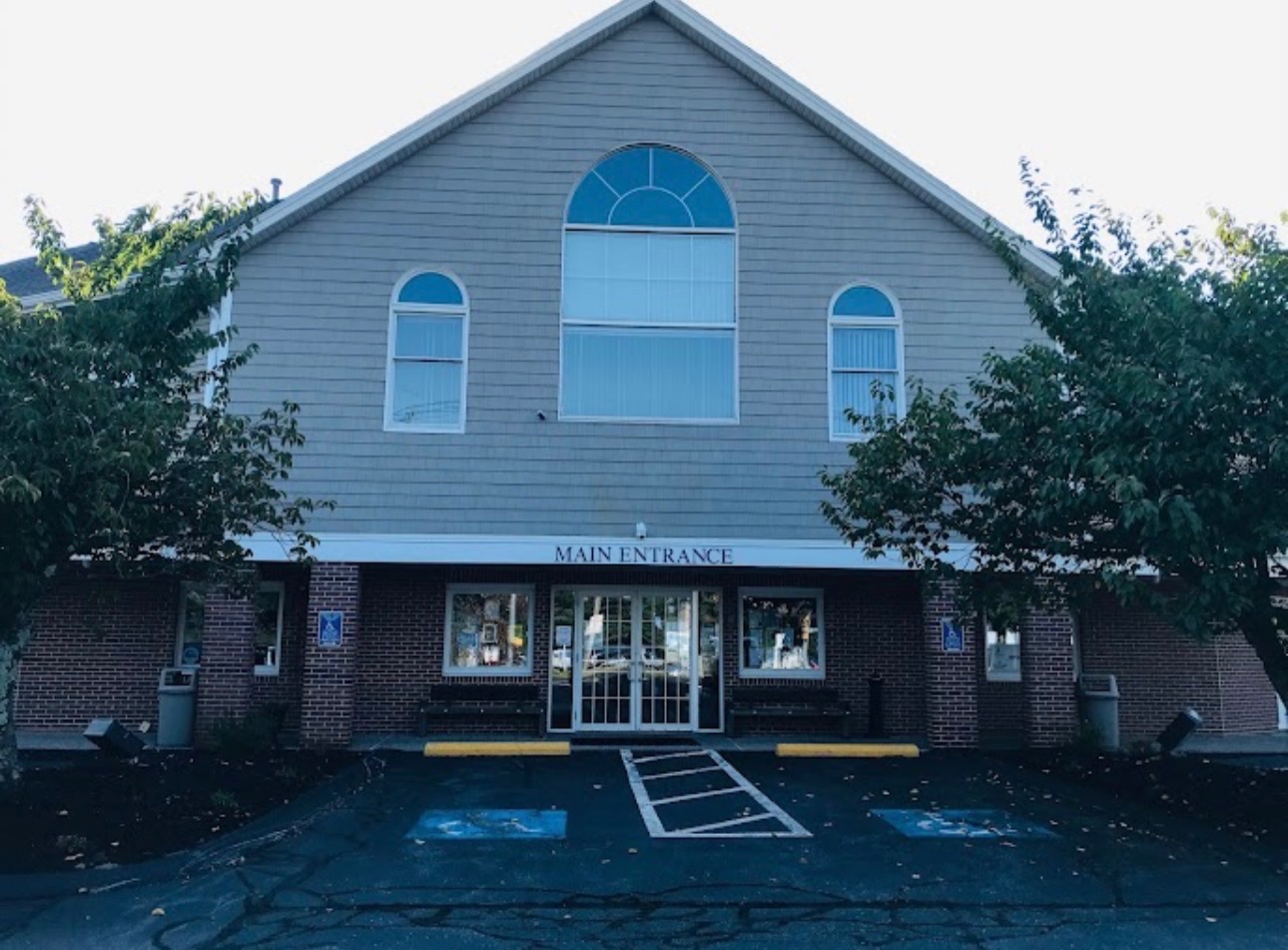 Exterior of the office building at 77 West Main Street, with the main entrance visible